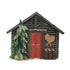 Chalet enneigé et pin